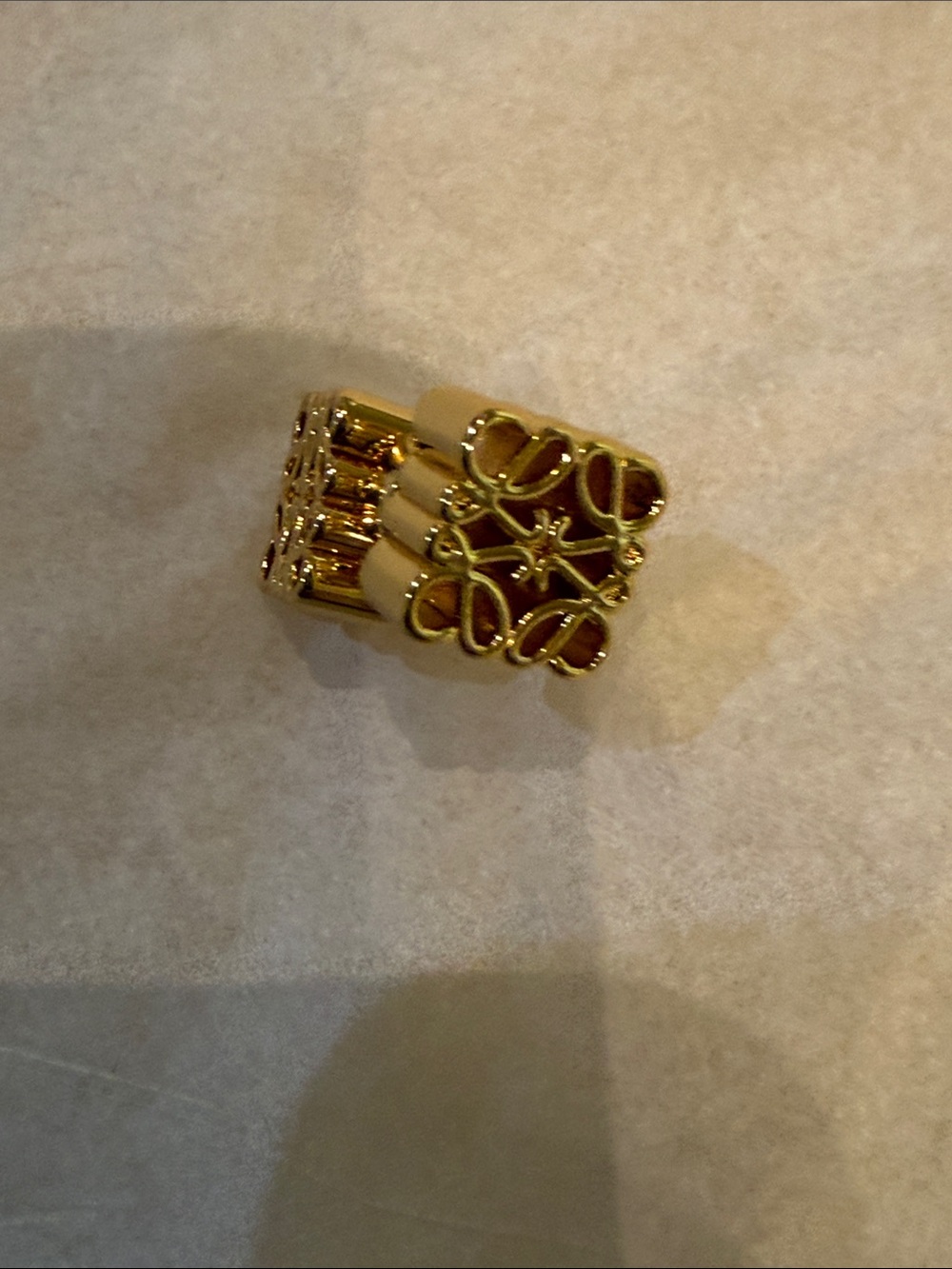 Gold Tone Ribbed Logo Stud Earrings - Picture 2 of 6